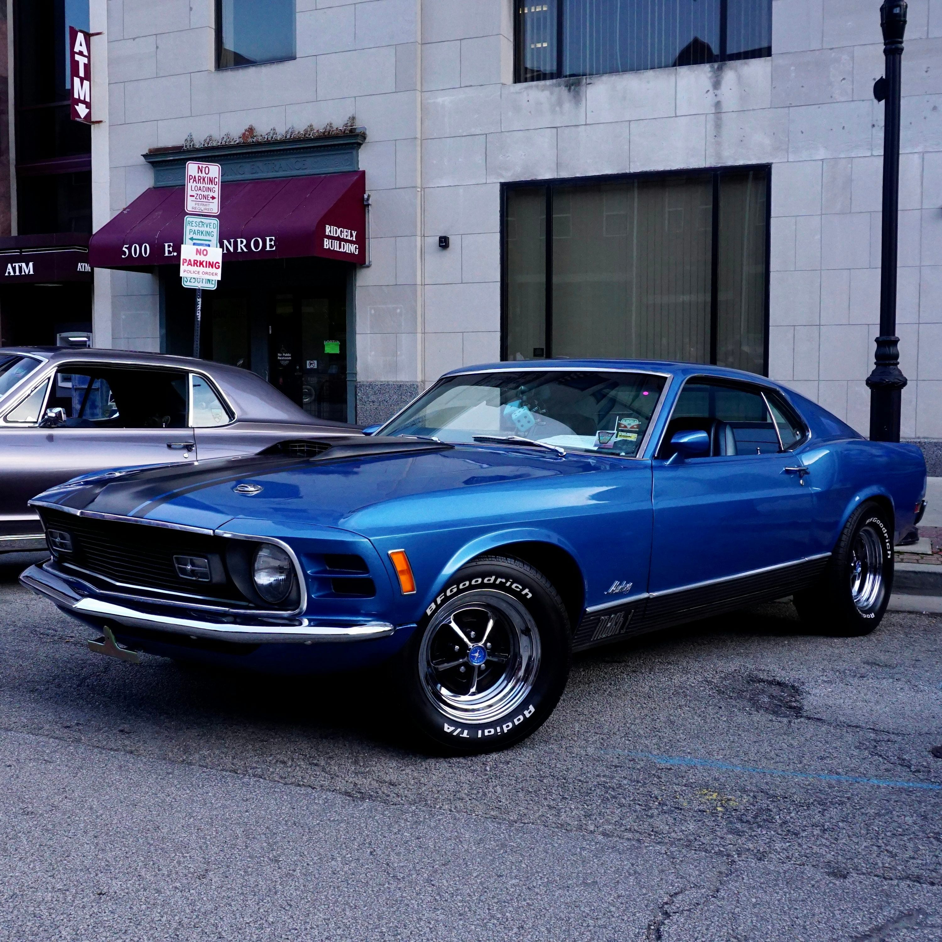 Blue American muscle car parked on a city street